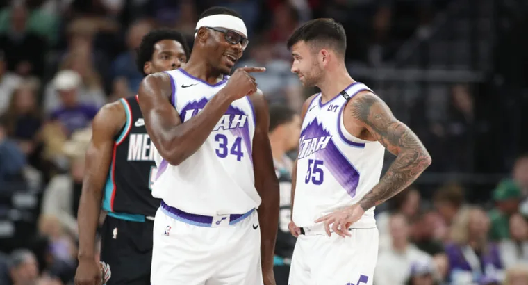 Utah Jazz players #34 Oscar Tshiebwe and #55 John Konchar talking on court during Memphis Grizzlies vs Utah Jazz match at Delta Center