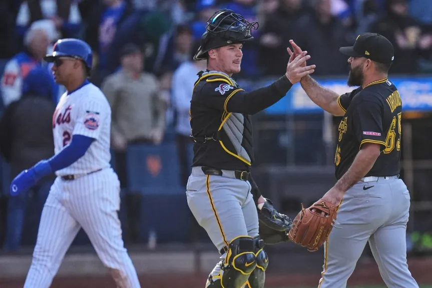 Pittsburgh Pirates catcher Henry Davis and pitcher Jose Urquidy high-fiving at Citi Field after securing a 4-3 win against the New York Mets.