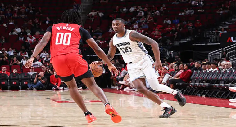 Memphis Grizzlies player dribbling the ball while guarded by Houston Rockets defender in NBA match