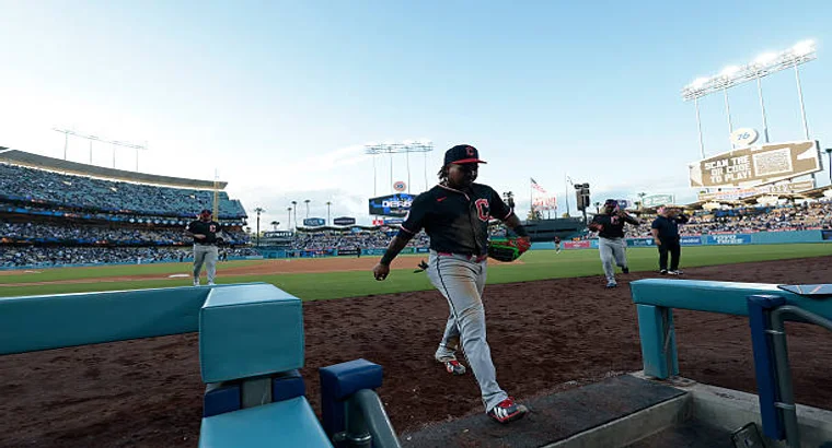 Cleveland Guardians player Jose Ramirez walking onto the field during a game at Dodger Stadium with crowd in background
