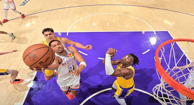 
OKC Thunder player #21 attacks the rim against Lakers defender at Crypto.com Arena, April 7, 2026