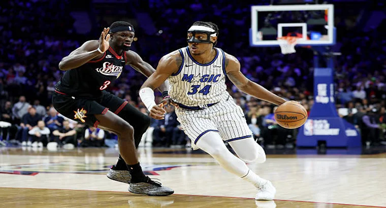 Orlando Magic guard Desmond Bane (#34) drives past Philadelphia 76ers defender VJ Edgecombe (#3) during the 2026 NBA SoFi Play-In Tournament East game at Xfinity Mobile Arena on April 15, 2026.