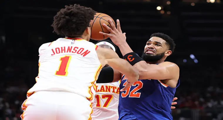 Atlanta Hawks forward Jalen Johnson (#1) contests New York Knicks center Karl-Anthony Towns (#32) during Game 6 of the 2026 NBA Playoffs at State Farm Arena