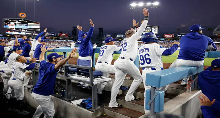 Los Angeles Dodgers players celebrating in the dugout during the Phillies vs Dodgers MLB game at Dodger Stadium on October 9, 2025