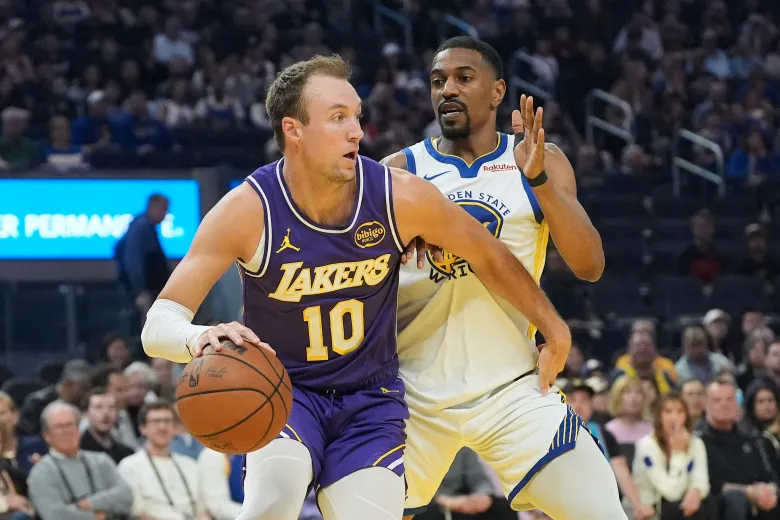 Lakers player #10 Luke Kennard drives with the ball while a Golden State Warriors defender attempts to cut him off during the April 9, 2026 NBA match at Chase Center