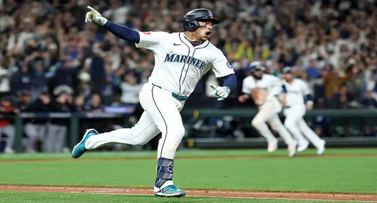 Seattle Mariners player pointing and celebrating after hitting a walk-off to beat the Detroit Tigers in 15 innings at T-Mobile Park